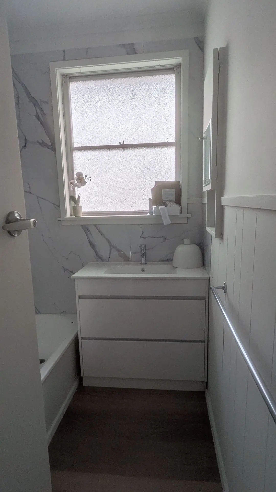 Bathroom transformation with marble-effect wall panels, modern vanity, updated plumbing fixtures, and crisp finishes in Winston Street, Morwell.
