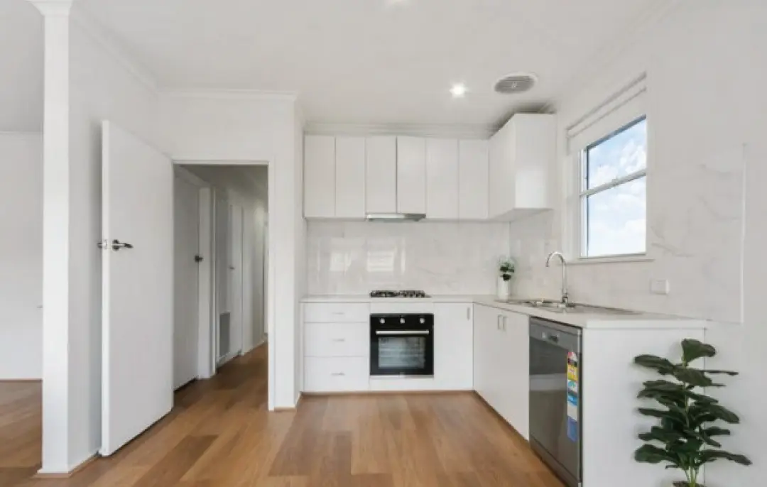 Kitchen transformation with marble-look splashback, stainless-steel appliances, and hybrid timber flooring in Winston Street Morwell home.
