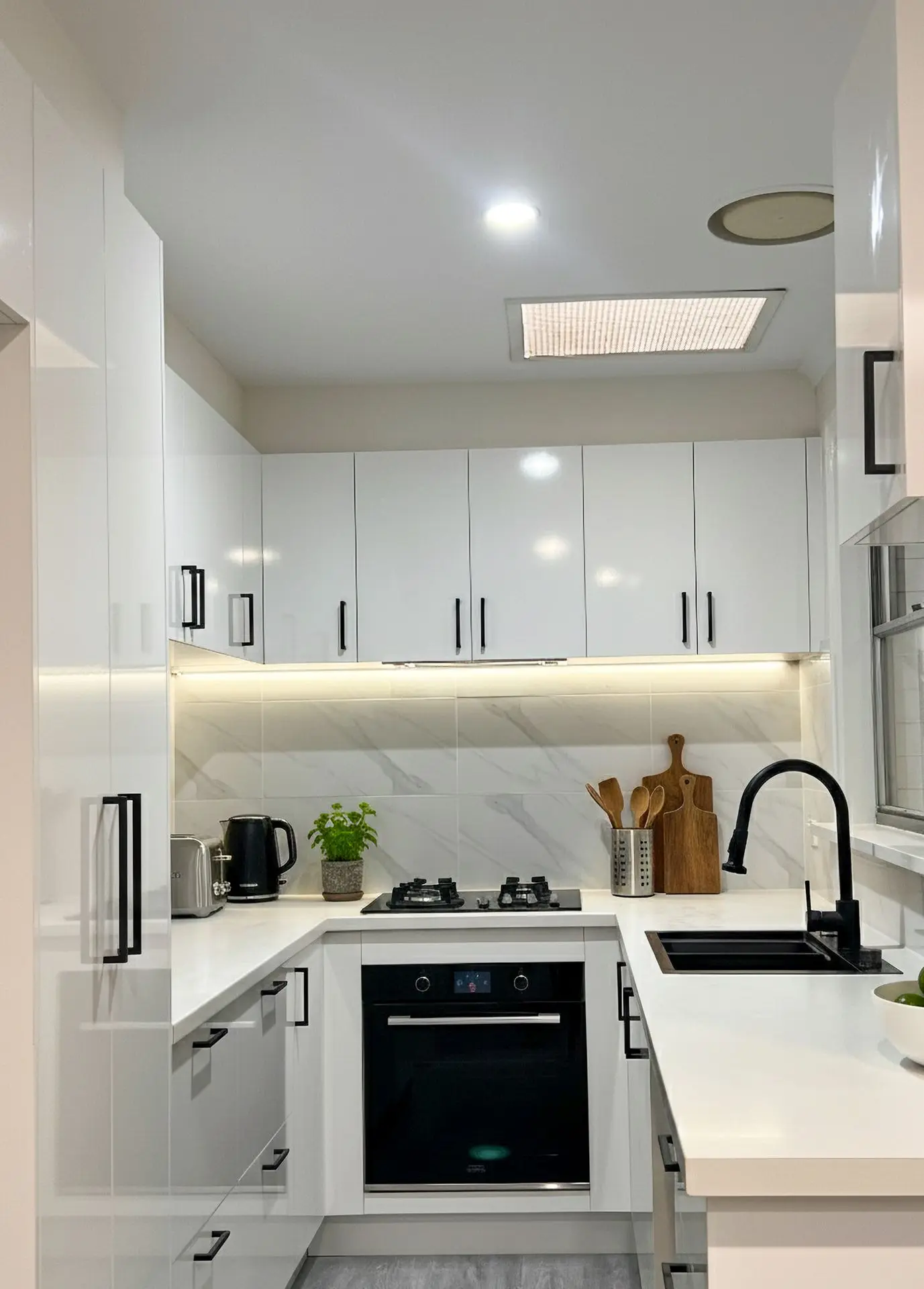 Affordable tiled splashback installation in “Bianco Carrara” finish