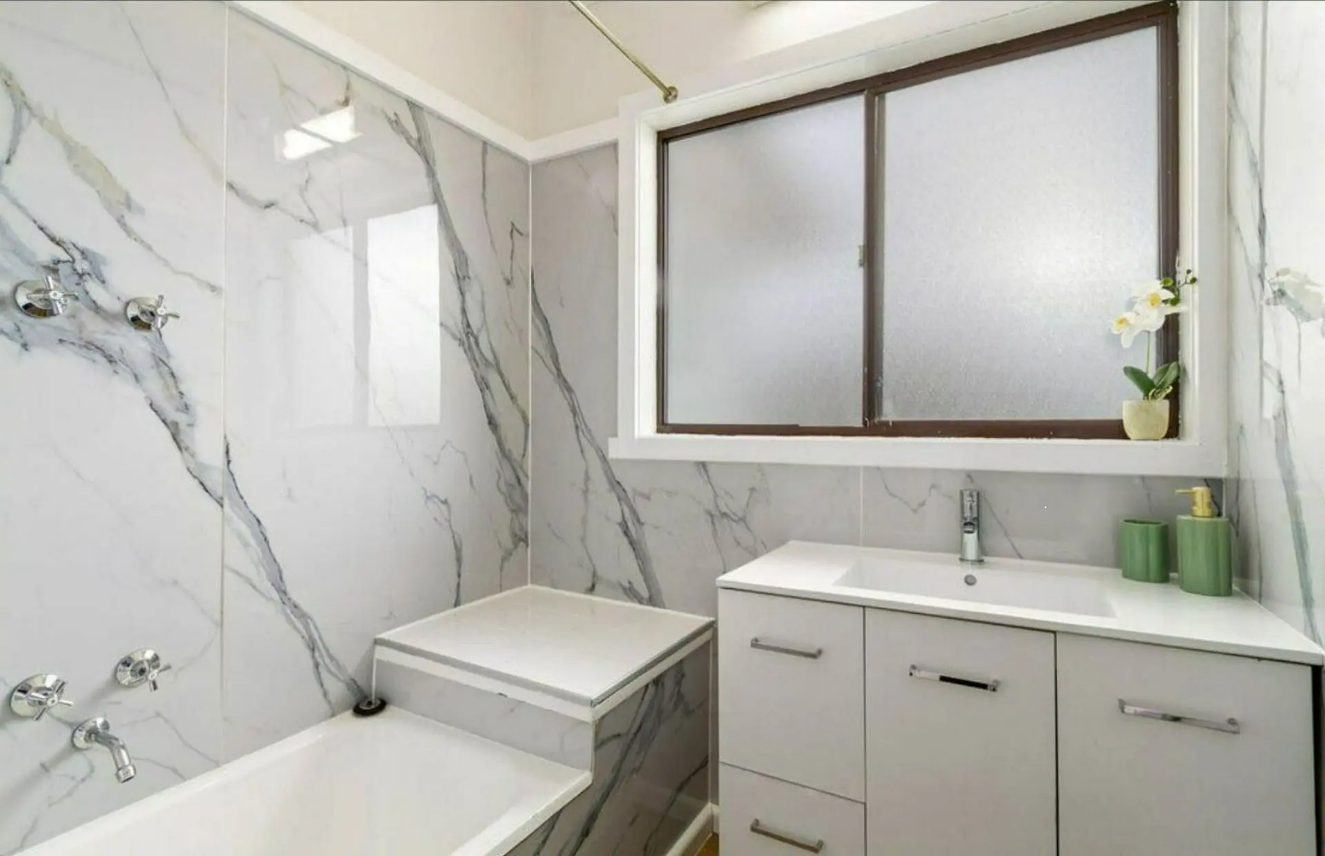 Bathroom renovation Morwell with marble wall panels and modern vanity unit