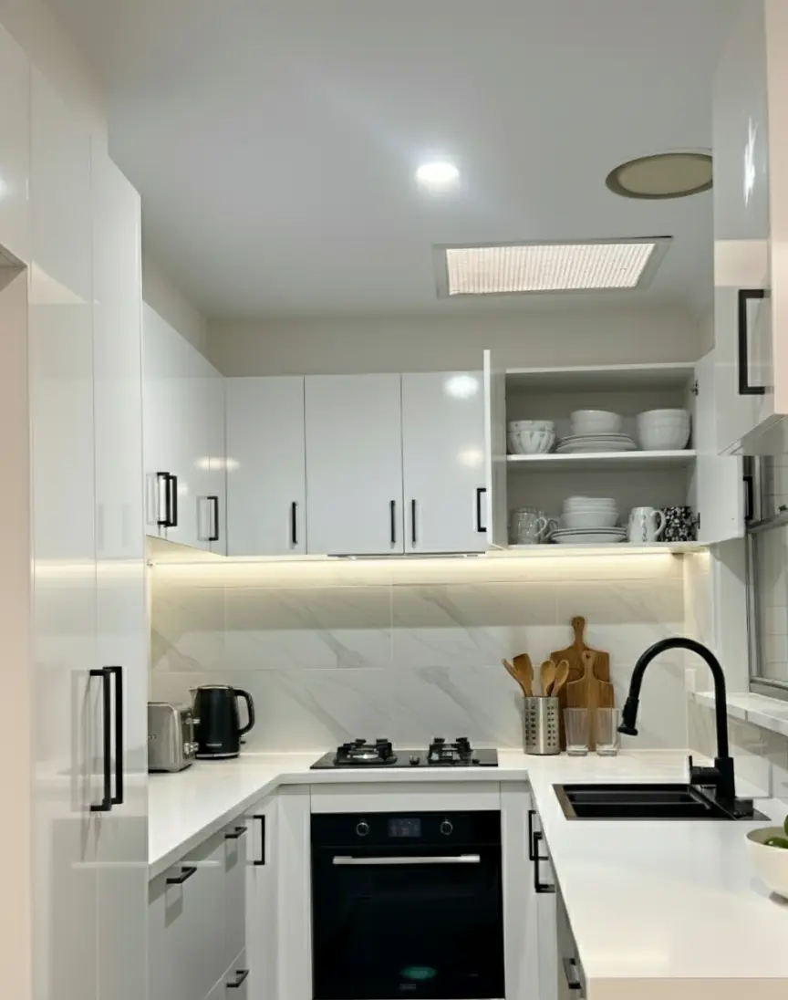 Cheap Polytec white cabinetry installation with black handle accents