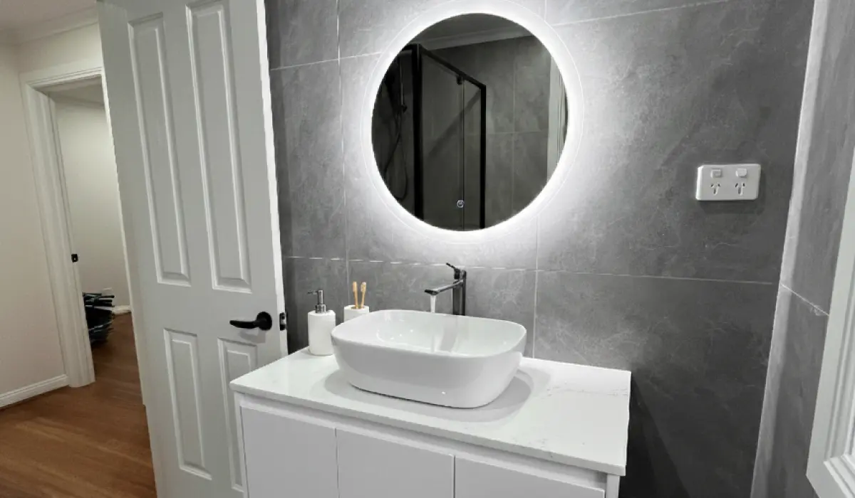 Affordable bathroom renovation with upgraded plumbing, LED lights, stone vanity and modern tapware for a stylish update.
