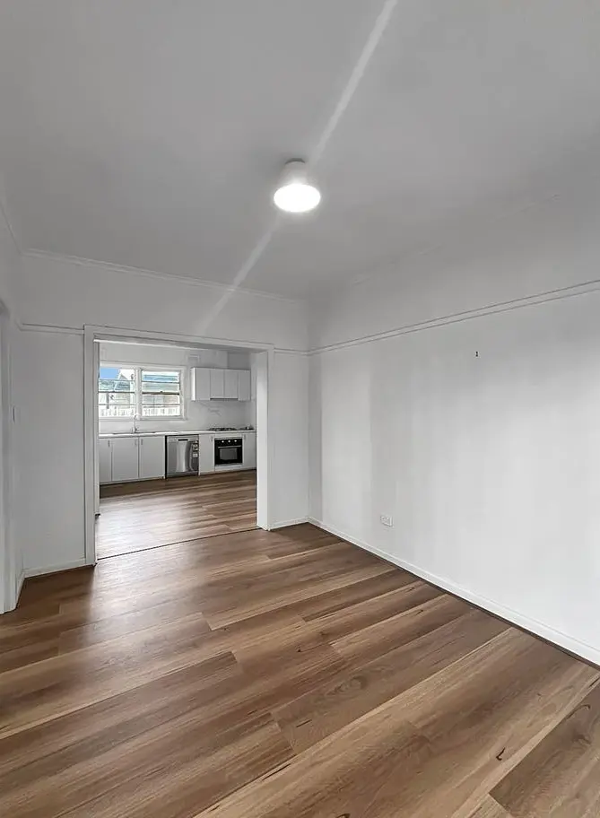 Cheap flooring option used in bedroom renovation, offering a warm and cost-effective finish.