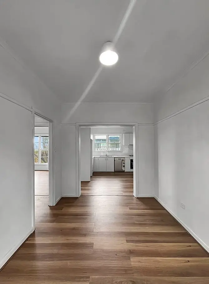 Waterproof Blackbutt hybrid flooring installed for a warm, natural timber look with long-lasting durability.