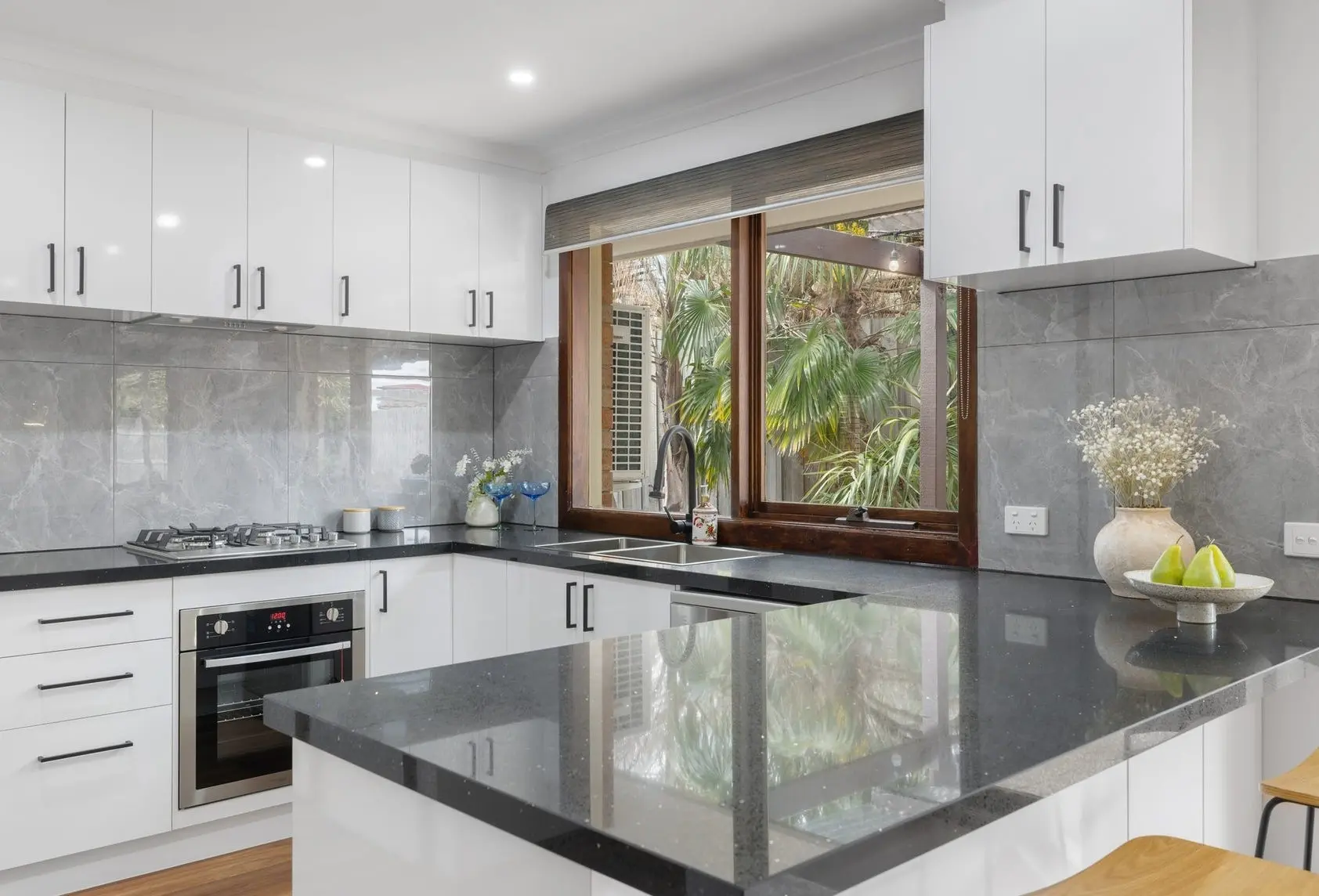Cheap kitchen renovation Melbourne with new cabinetry, benchtops, and splashback