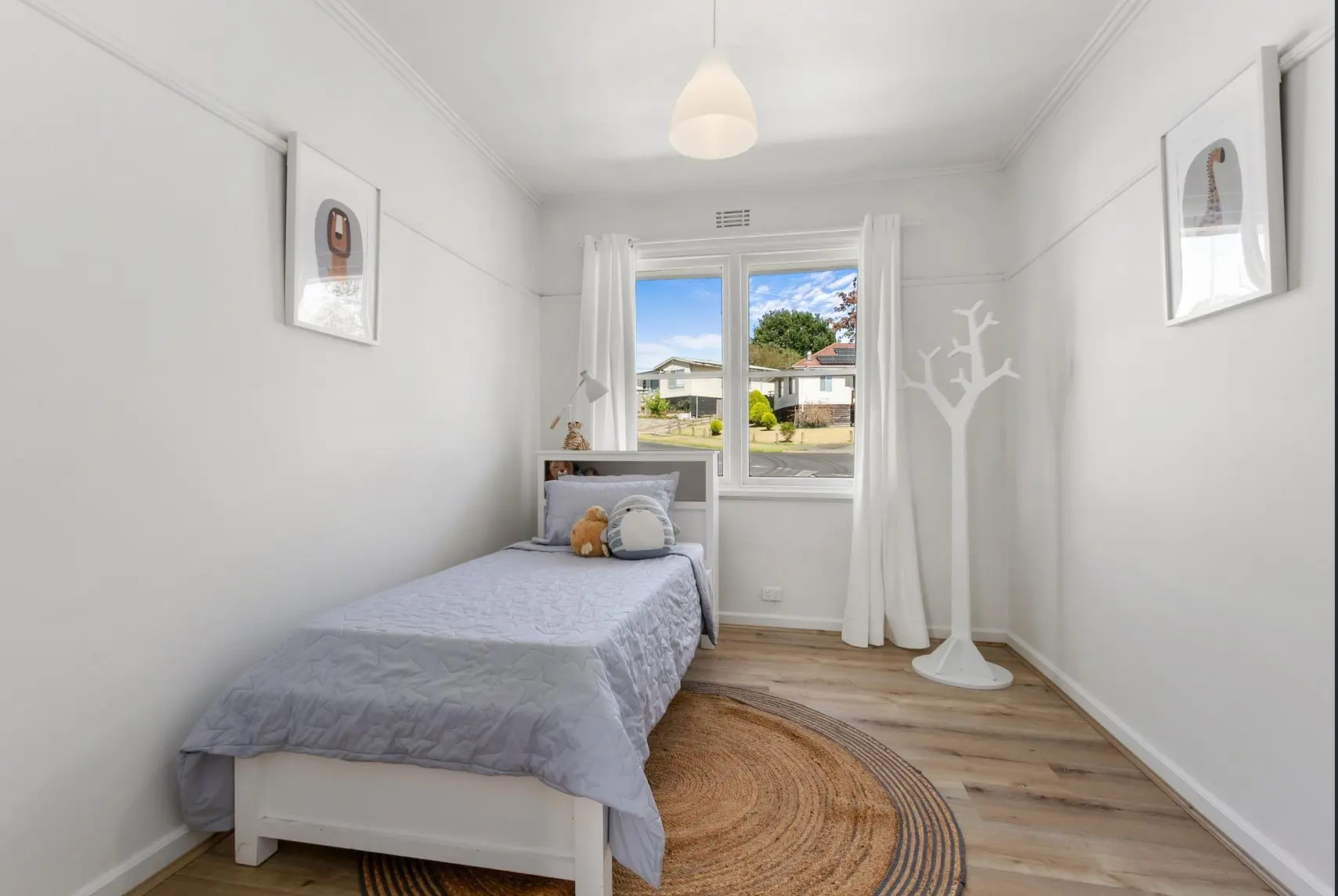 Budget small room renovation with new hybrid flooring, white roller blinds and fresh interior painting for a bright modern space.