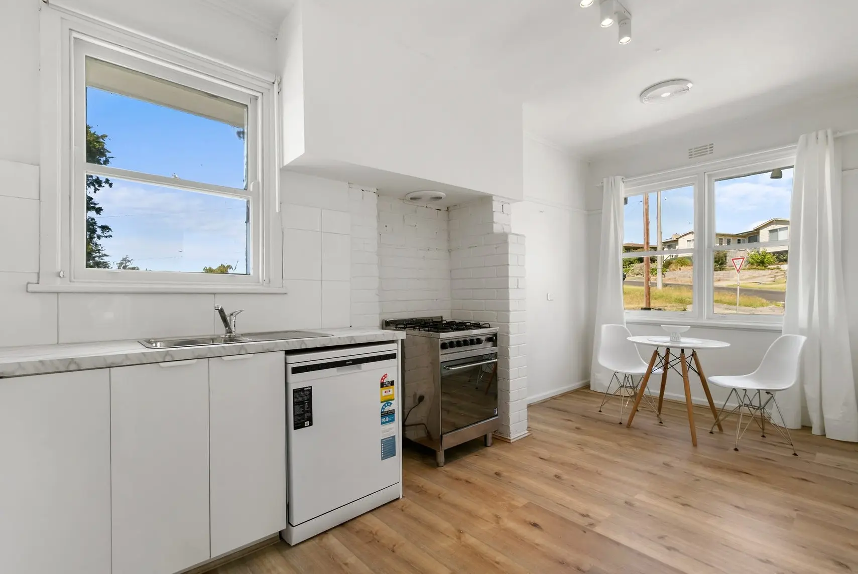 Quick kitchen renovation Morwell with white cabinets and modern lighting upgrade.