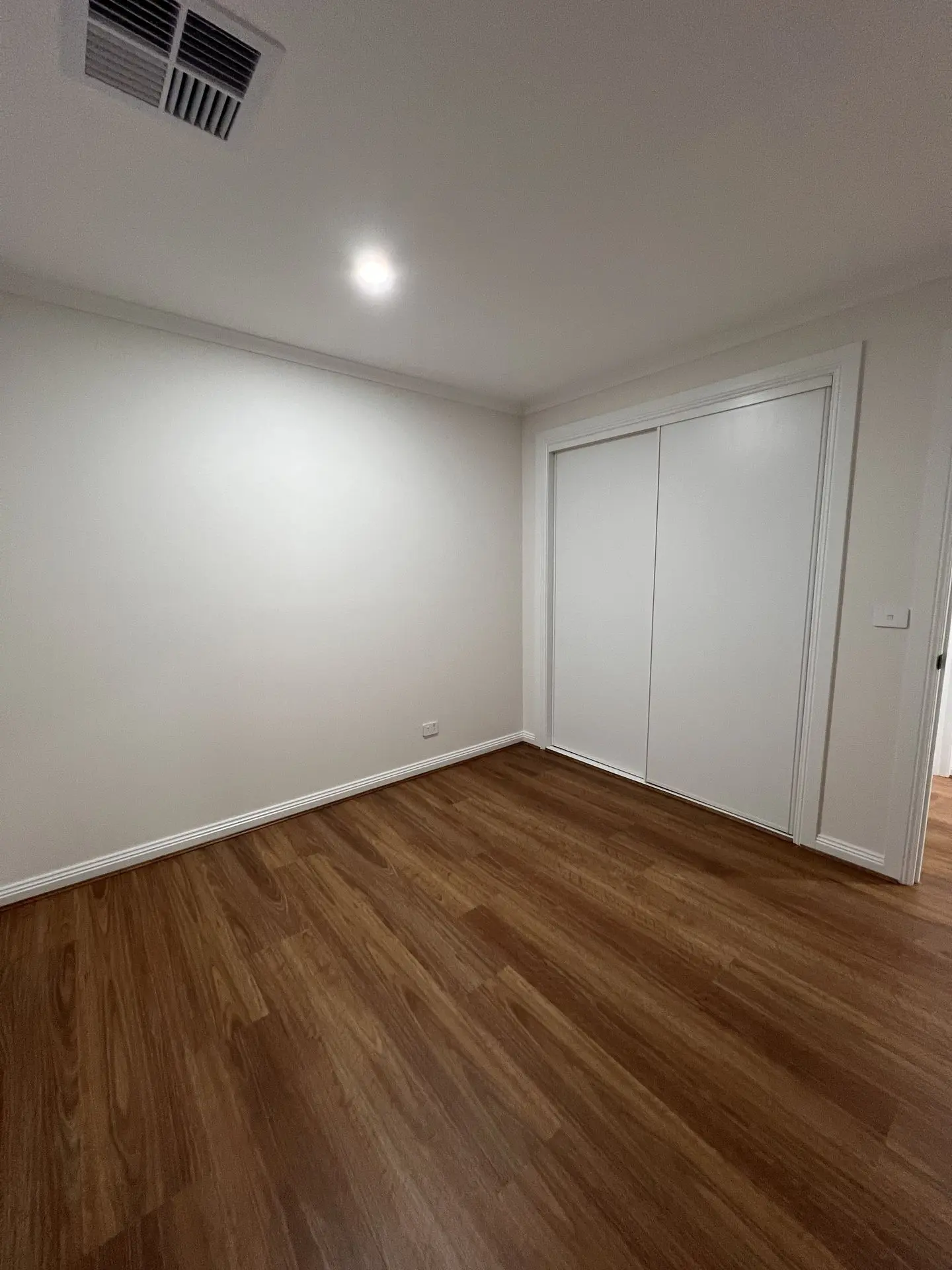 Open living room with spotted gum hybrid flooring and modern furnishings