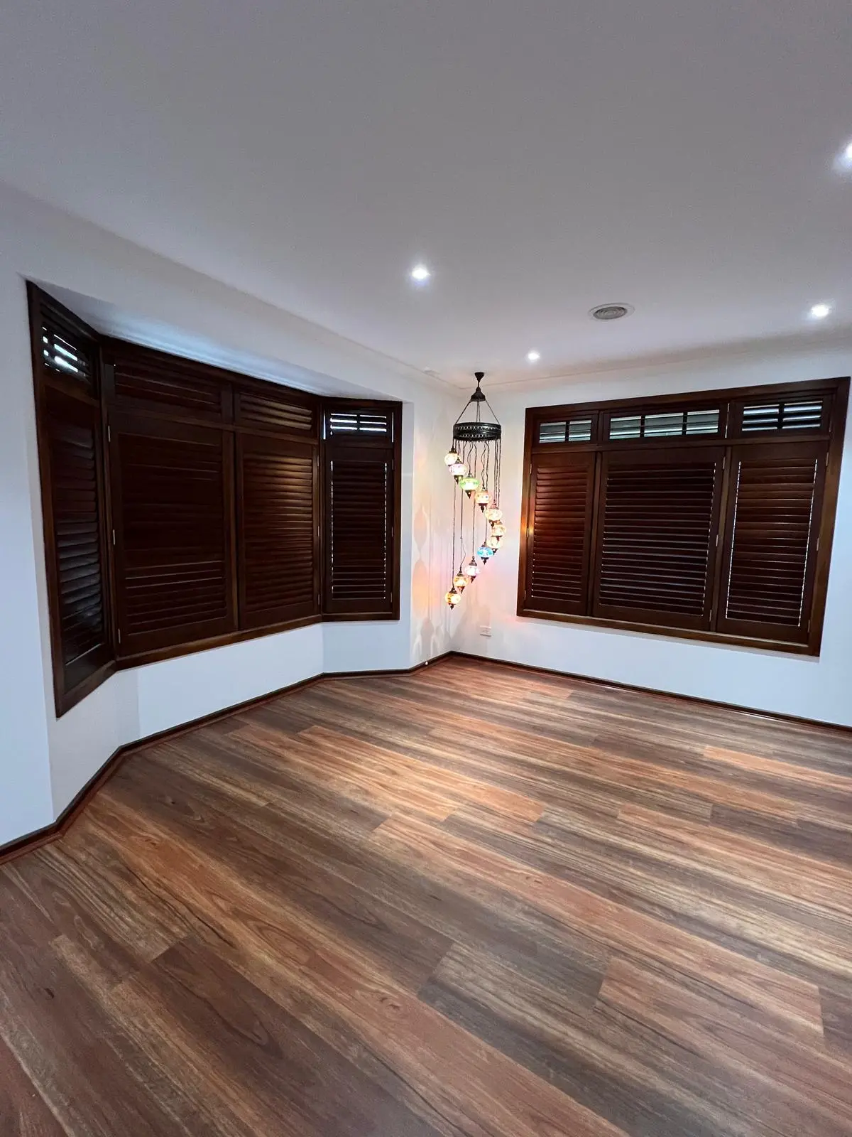 Living room transformation using warm timber-tone hybrid flooring