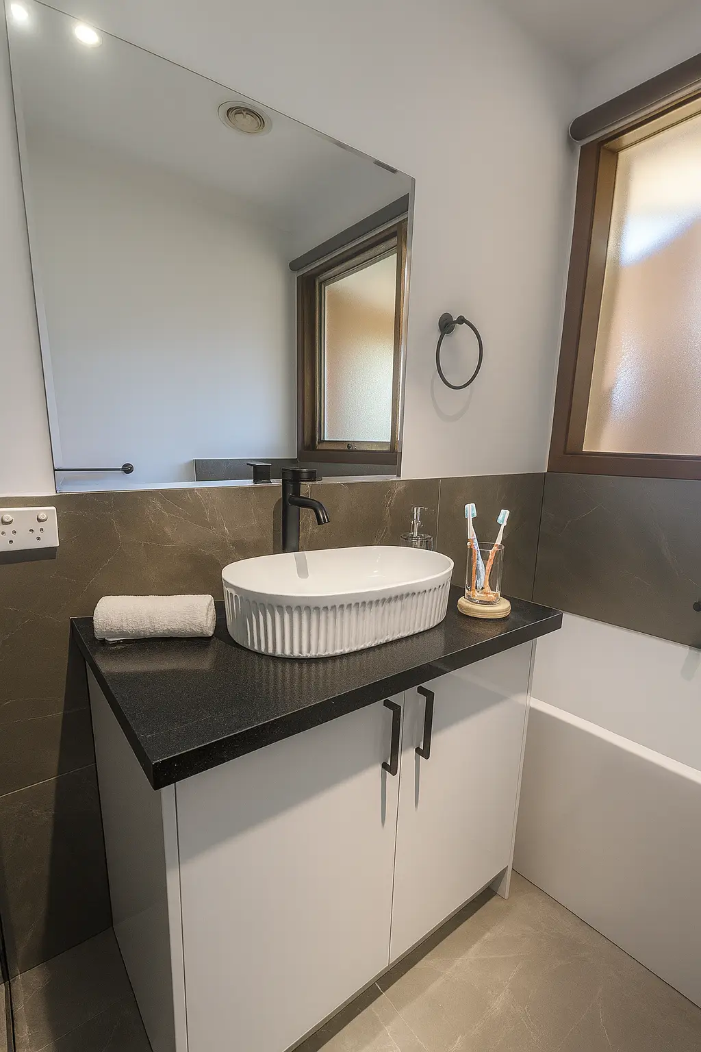 Modern bathroom renovation featuring upgraded benchtop and tapware