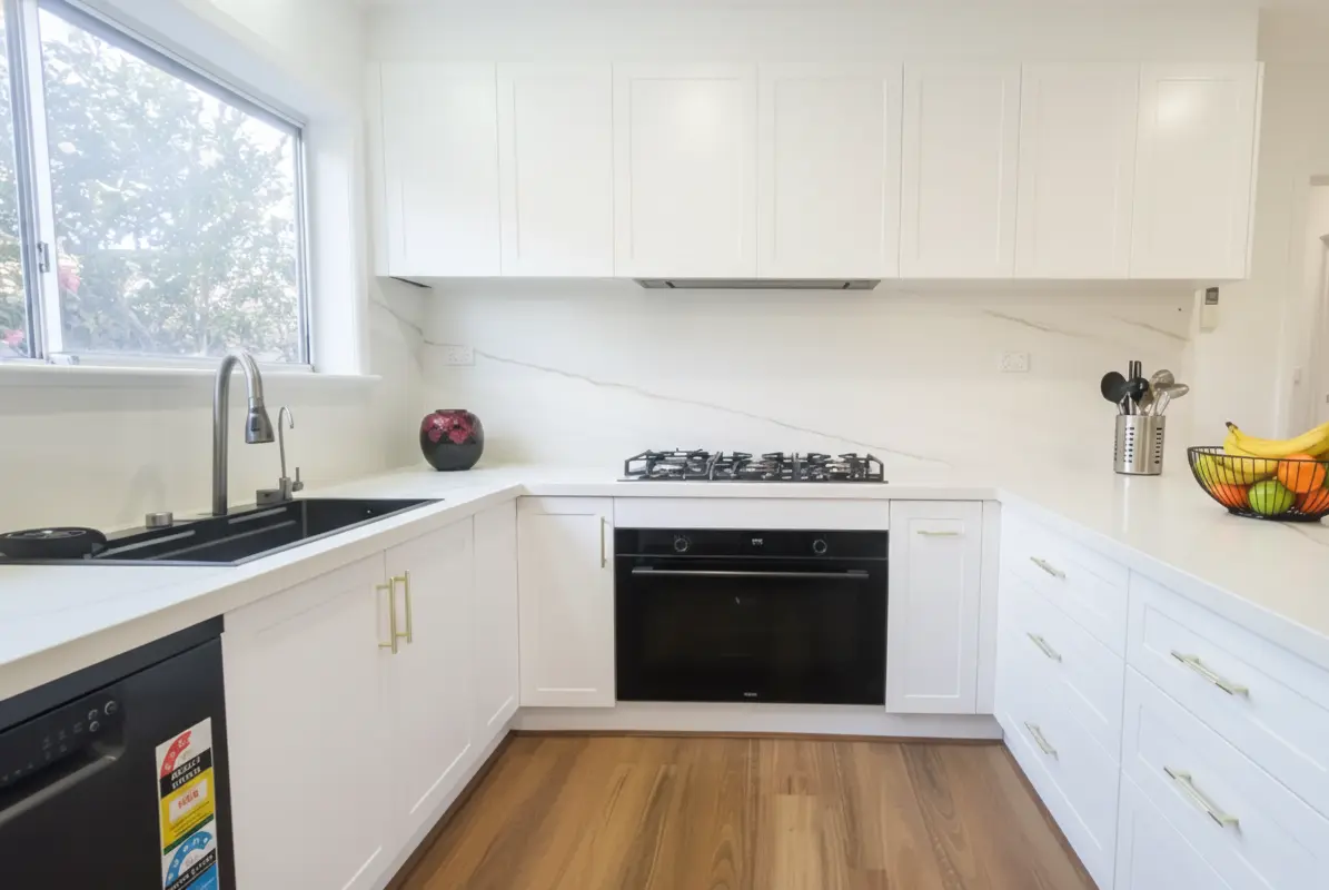 Fast kitchen remodel showing hybrid flooring, custom drawers, and updated interior painting for a clean modern finish.