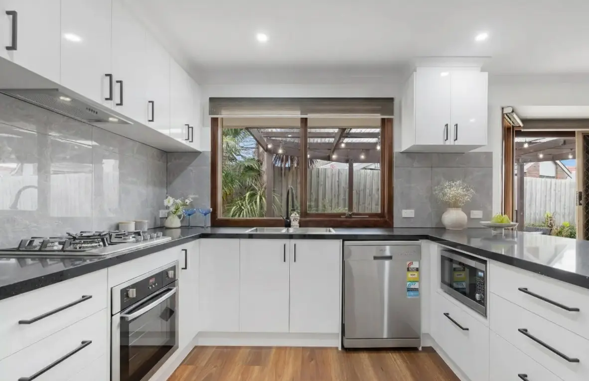 Large-format grey tiled splashback in modern Melbourne kitchen renovation.