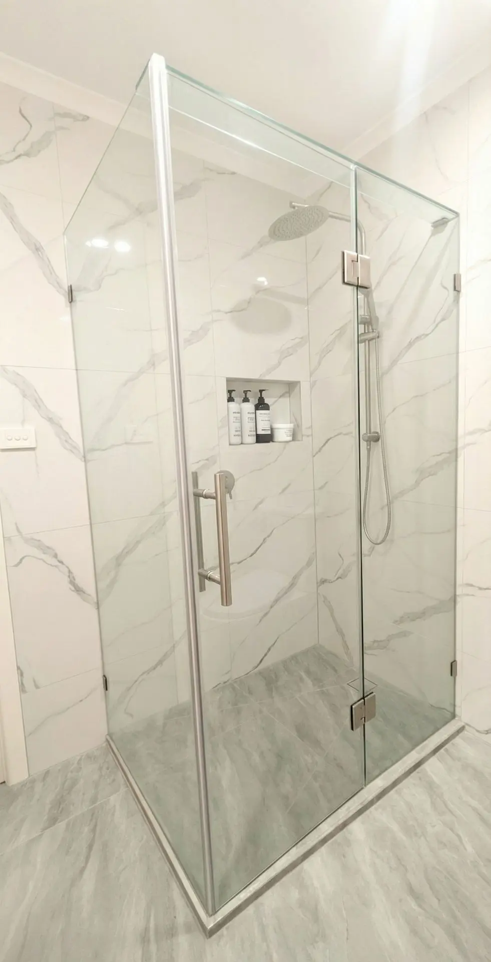 White porcelain grey-vein tiles used in contemporary bathroom renovation.