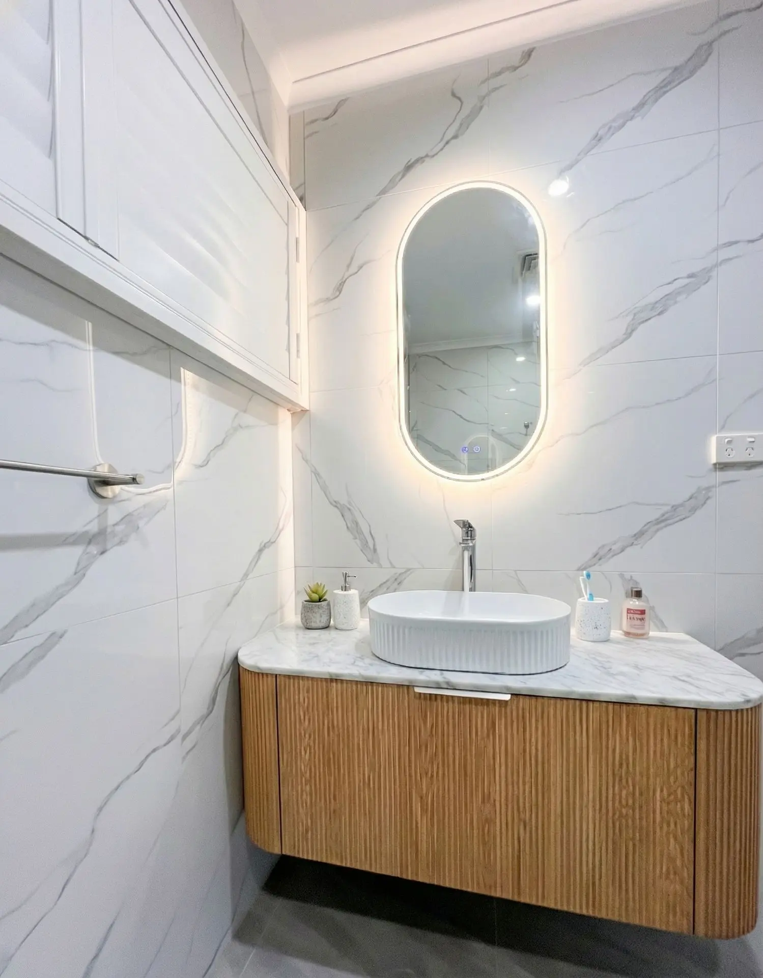 Budget bathroom renovation with new vanity, fixtures, and modern finishes.