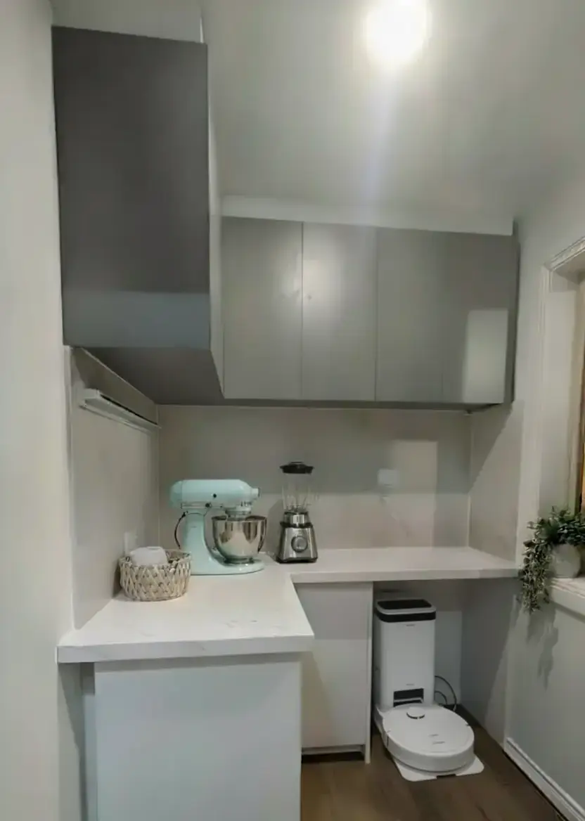 pantry renovation with custom cabinetry, stone benchtops, Taj Mahal stone splashback and overhead storage.