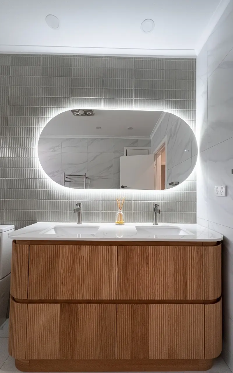 Contemporary bathroom renovation in Mt Waverley with timber vanity and LED mirror